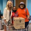 Board President, Kelly Bettencourt, distributes FoodShare box to client and her grandson